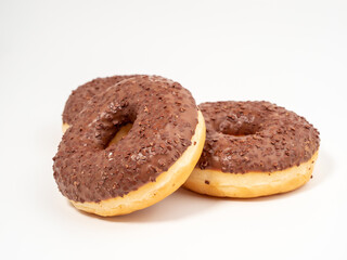 Chocolate donut with chocolate chips on a white background. close-up.