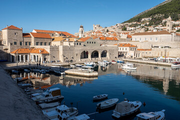 Dubrovnik city port full with anchored boats, observed from the fortified city walls