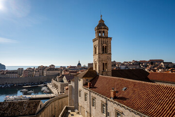 Fototapeta na wymiar Amazing Dubrovnik city walk on defence walls, above city rooftops and wonderful stone houses and landmarks