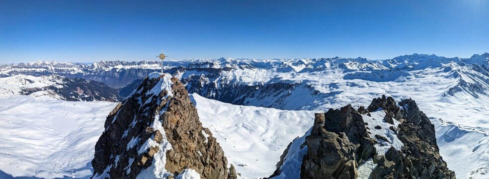 On the peak spitzmeilen above the Flumserberg. Ski mountaineering in the beautiful Swiss Alps. Ski touring in Glarus. Summit cross. High quality photo