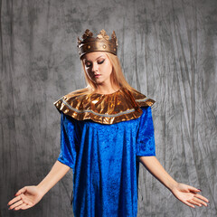 The ruler in a golden crown and shoulder strap, simplified Byzantine or Russian style. Beautiful young queen in blue