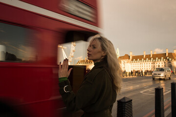 woman relaxing by the westminster bridge London Big Ben and westminster parlement, London UK by the...