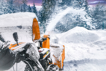 Clearing snow with a snowblower after snow fall.