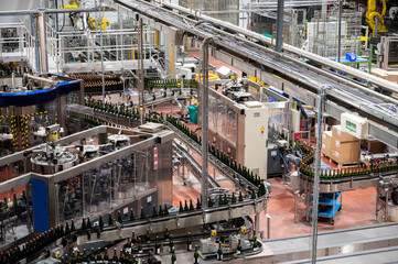 Production of cremant sparkling wine in Burgundy, France. Automatically powered bottling lines on factory.