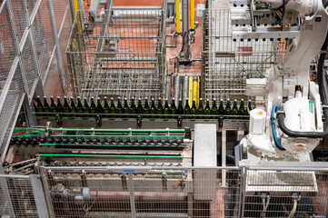 Production of cremant sparkling wine in Burgundy, France. Automatically powered bottling lines on factory.