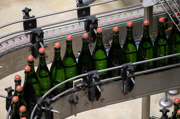Production of cremant sparkling wine in Burgundy, France. Automatically powered bottling and...