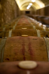 Old french oak wooden barrels in cellars for wine aging process, wine making in La Rioja region, Spain