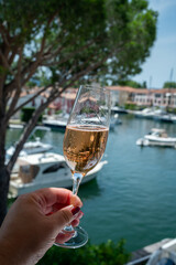 Summer party, drinking of French brut champagne sparkling wine in glasses in yacht harbour of Port Grimaud near Saint-Tropez, French Riviera vacation, France