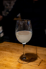 Pouring of txakoli or chacolí slightly sparkling very dry white wine produced in Spanish Basque Country in pinchos bar in old part of San Sebastian or Donostia, Spain