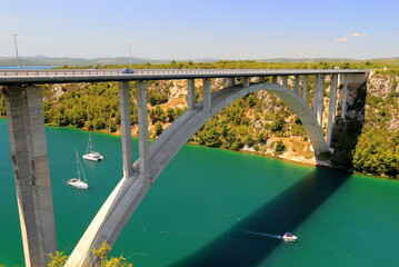 Arched bridge across Krka river in Croatia. Croatian river landscape in spring and summer, Europe....