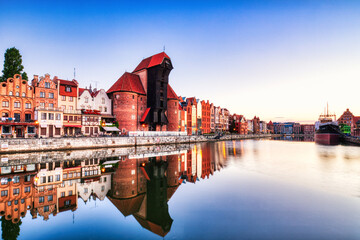 Illuminated Gdansk Old Town with Calm Motlawa River at Sunrise, Poland