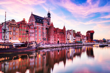 Fototapeta na wymiar Illuminated Gdansk Old Town with Calm Motlawa River at Sunset, Poland