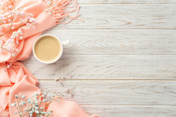 Hello spring concept. Top view photo of mug of coffee gypsophila flowers and pink plaid on grey wooden desk background with empty space
