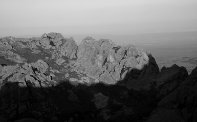 Fototapeta na wymiar Black and white shot of the rock massif The Giants in Cordoba, Argentina. View of the rocky hills at sunset.