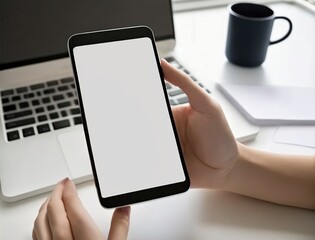 Mockup, blank screen smartphone. women hand holding, laptop and office in the background, insert for screen