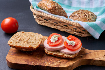 Sandwich with sausage and tomatoes.