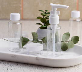 Transparent plastic container for cosmetics on the table, bottles for liquid cosmetics