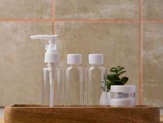 Transparent plastic container for cosmetics on the table, bottles for liquid cosmetics