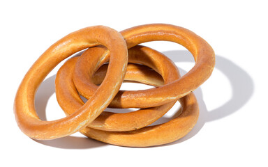 Baked round bagel made of white wheat flour on a white isolated background