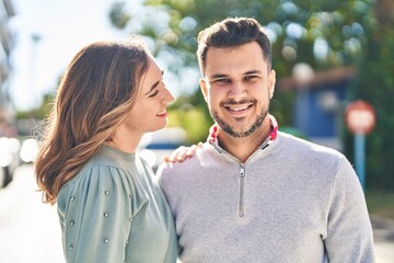 Fototapeta premium Man and woman smiling confident hugging each other standing at street