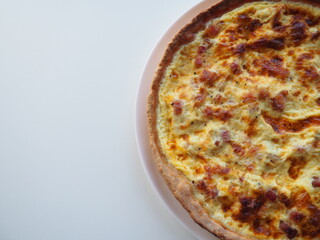 Homemade traditional french Quiche Lorraine, real recipe, white background, half view, space for text