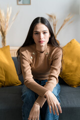 Young woman sitting on sofa