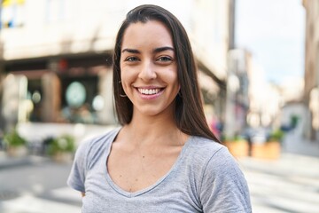 Young beautiful hispanic woman smiling confident standing at street