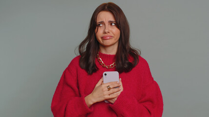 Hipster pretty woman use mobile cell phone typing browsing, loses becoming surprised sudden lottery...