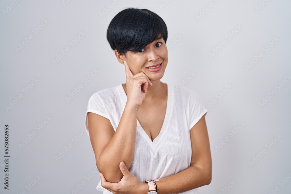 Sticker young asian woman with short hair standing over isolated background thinking worried about a questio