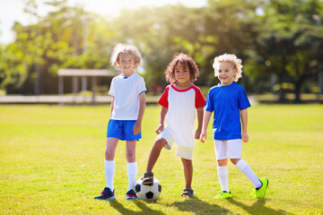 Obraz premium Children play football. Group of boys playing.