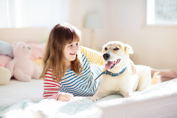 Child playing with dog. Kids play with puppy.