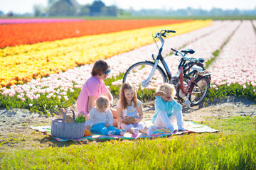 Family picnic at tulip flower field, Holland