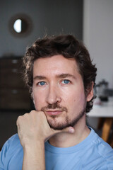 Fototapeta premium Handsome young man with blue eyes and curly wavy hair