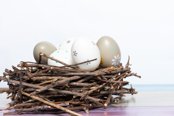 Painted Easter eggs in a nest of twigs.