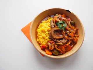 Italian Osso Buco alla Milanese : veal shank stew and safran risotto, white and orange background, space for text