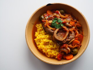 Italian Osso Buco alla Milanese : veal shank stew and safran risotto, white background, space for text