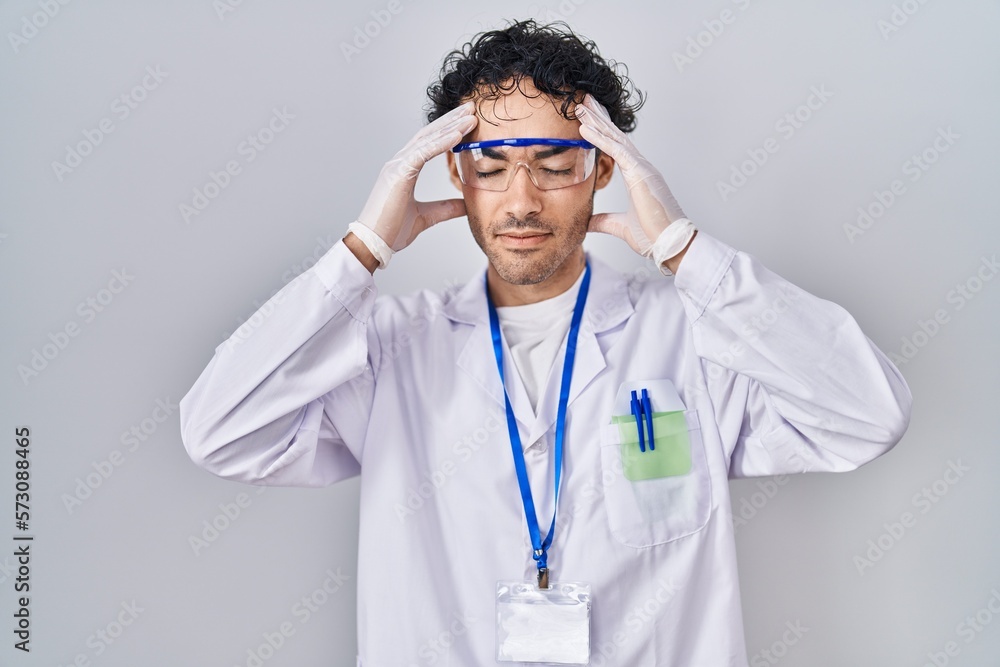 Sticker Hispanic man working at scientist laboratory with hand on head, headache because stress. suffering migraine.