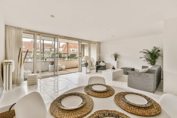 a living room with white furniture and large sliding glass doors that open onto the balcony...