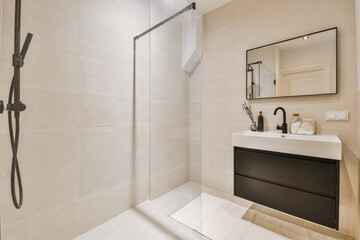 a modern bathroom with white tiles and black fixtures in the shower stall, it's all ready to use