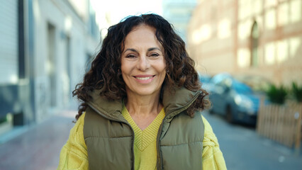 Fototapeta premium Middle age hispanic woman smiling confident at street
