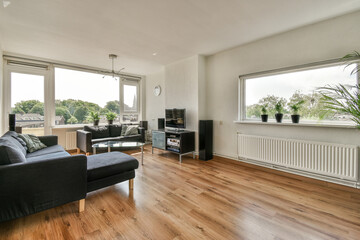 a living room with wood flooring and large windows looking out onto the cityscapearrons com