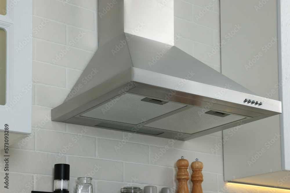 Sticker Modern range hood over shelf with spices in kitchen