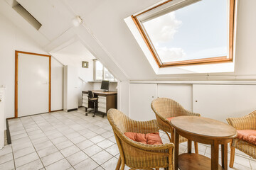 a kitchen and dining area in an attic style home with skylights on the roof, white walls and tiled...