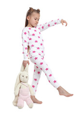 Girl in pajamas with toy bunny sleepwalking on white background