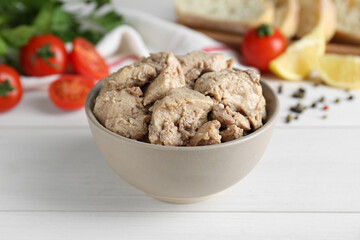 Bowl of tasty cod liver on white wooden table