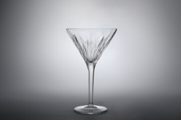 Elegant empty martini glass on grey background