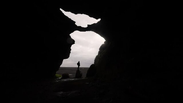 Man Standing Still At The Entrance Of Gigjagja Cave