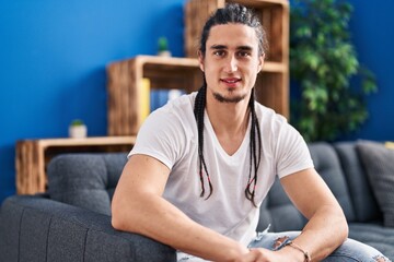 Young man smiling confident sitting on sofa at home