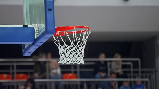 basketball player putting a ball in the hoop, closeup sports concept indoors. High quality 4k footage
