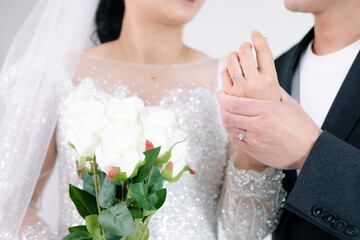 Young married couple holding hands, ceremony wedding day,Wedding concept.